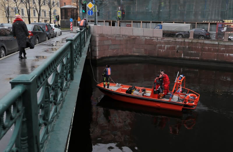 Investigators work at a probable crime scene following the detention of Russian historian Sokolov in Saint Petersburg