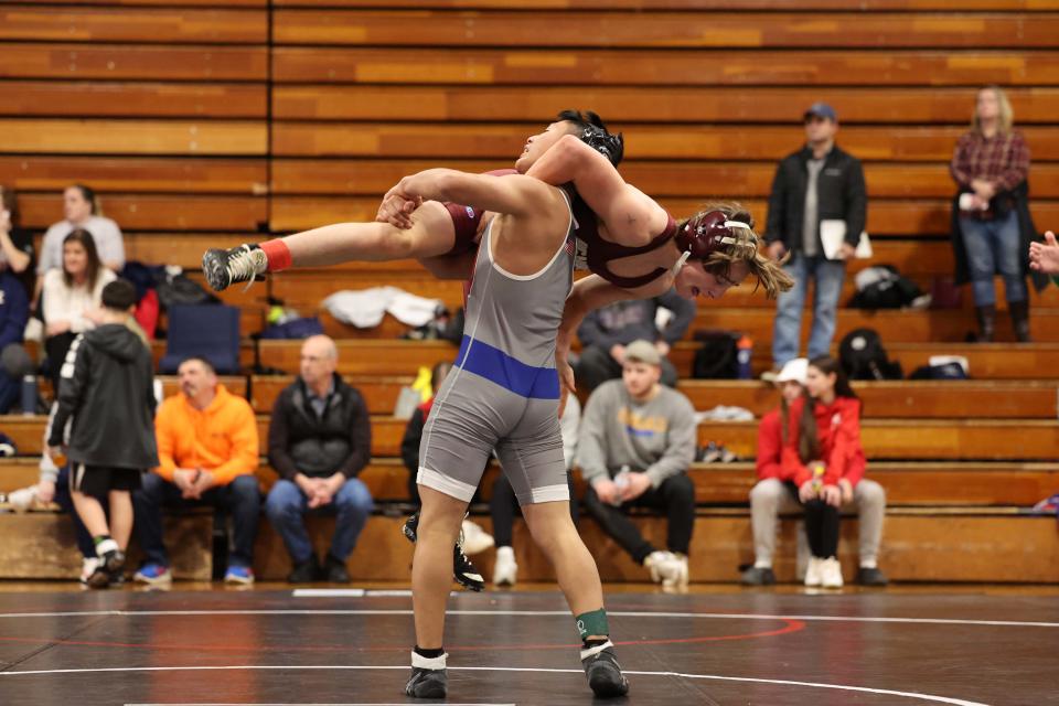 Boston College's John McCarthy versus North Quncy's Edwin Vino during the division one south sectional wrestling championships at Brockton High School on Saturday, Feb. 11, 2023.