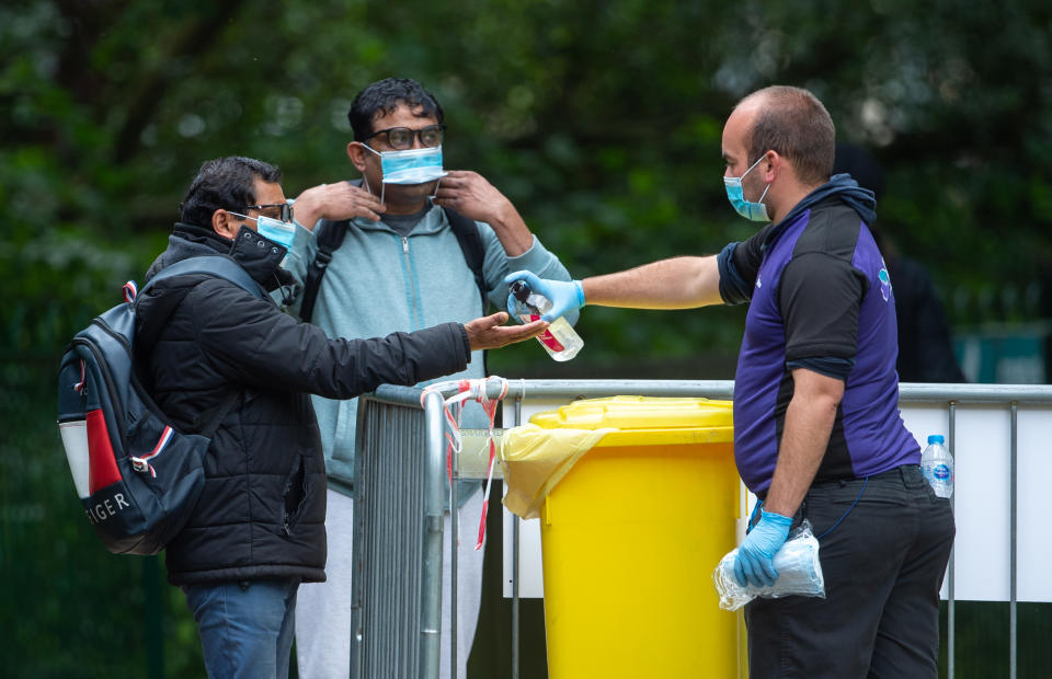 Members of the public sanitize their hands as they arrive at a Covid-19 testing centre in Spinney Hill Park in Leicester, where localised coronavirus lockdown restrictions have been in place since June 29, with non-essential shops ordered to close and people urged not to travel in or out of the area. Health Secretary Matt Hancock is due to decide whether to make changes to Leicester's lockdown after examining the latest coronavirus data. (Photo by Joe Giddens/PA Images via Getty Images)