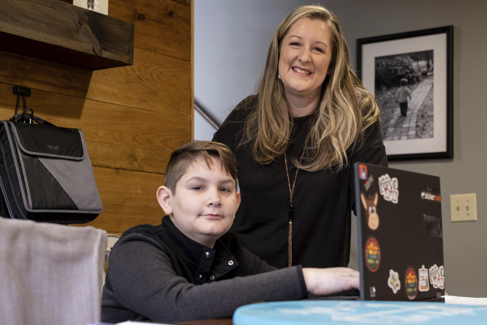 Kelli Rivera is photographed with her son Tate, 11 at their home in Roswell, Ga., Friday, Feb. 12, 2021. Rivera is hoping a voucher bill passes that will help pay for her to move her son out of a public Cobb County school and into a private school. (AP Photo/Ben Gray)