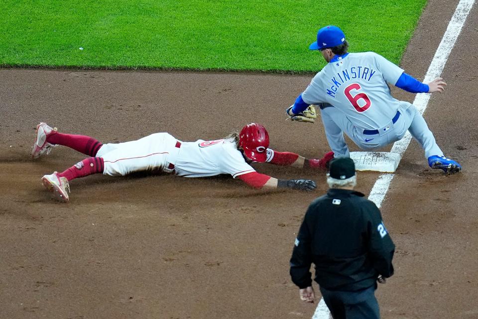 TJ Friedl is caught stealing and tagged out by Cubs third baseman Zach McKinstry in a game on Oct. 3.