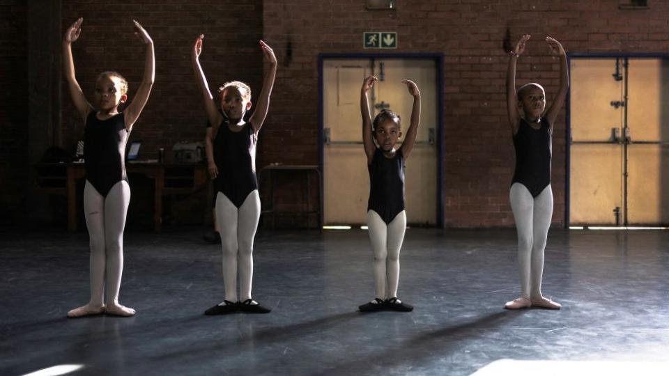 Pupils dance and listen to instructions during a ballet class in Alexandra near Johannesburg on March 19, 2024.
