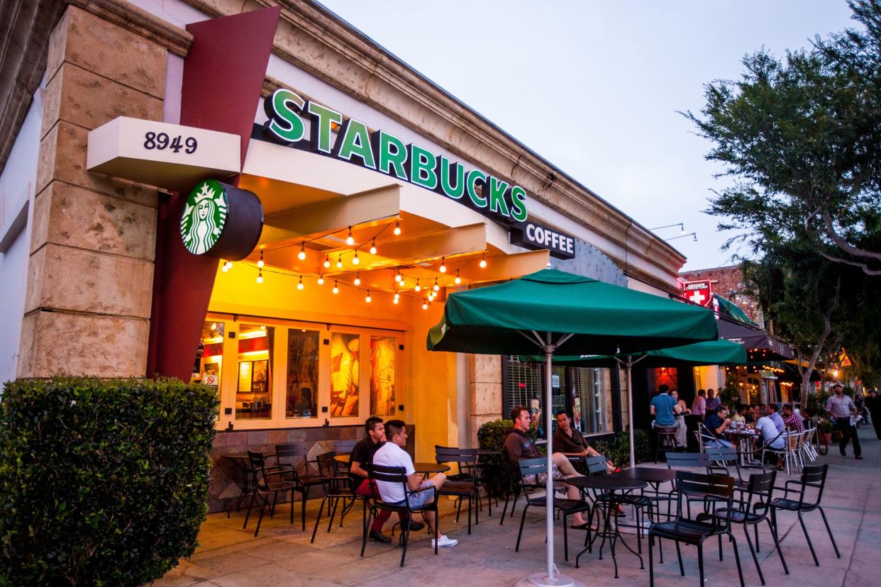 People sitting at Starbucks Coffee in West Hollywood, California