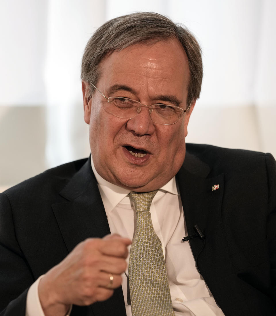 Governor of North Rhine-Westphalia Armin Laschet gestures as he speaks during an interview with the Associated Press in his office in Duesseldorf, Germany, Wednesday, June 30, 2021. Laschet is the CDU top candidate for the German general elections in September and the most likely successor to current chancellor Angela Merkel. (AP Photo/Martin Meissner)