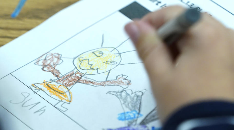 First grade student, Emma Benn, works on a drawing during classes at Chimborazo Elementary School Thursday, Nov. 17, 2022, in Richmond, Va. The Richmond school district, which includes Chimborazo elementary, ultimately decided against year-round school. (AP Photo/Steve Helber)