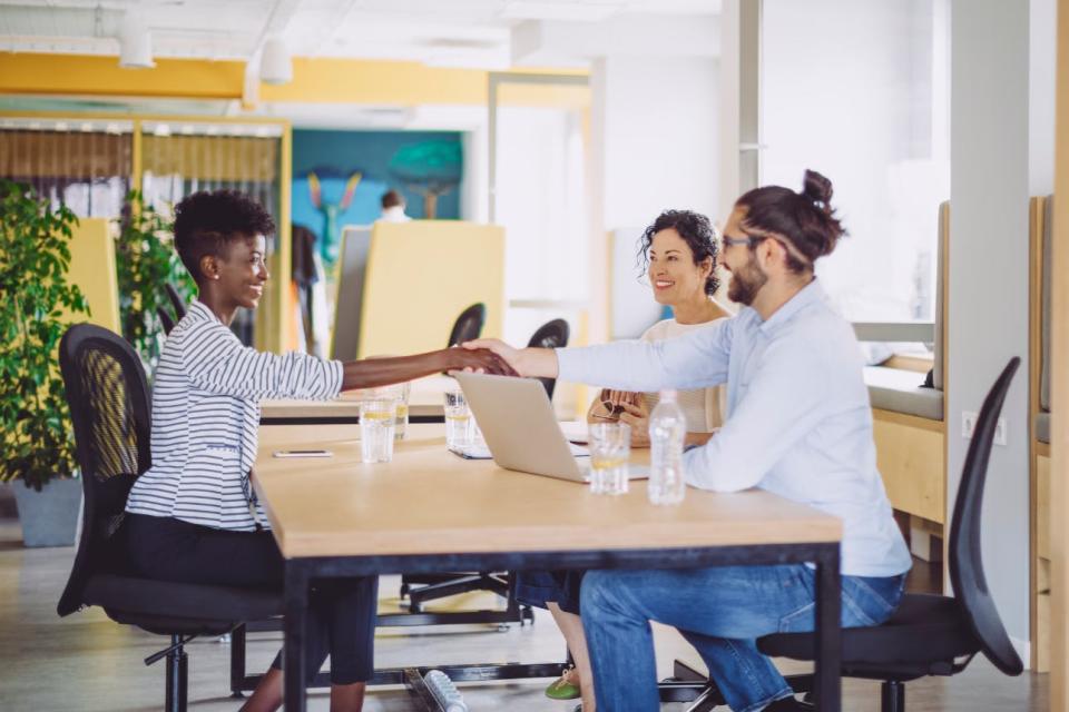 A candidate shakes hands at a job interview