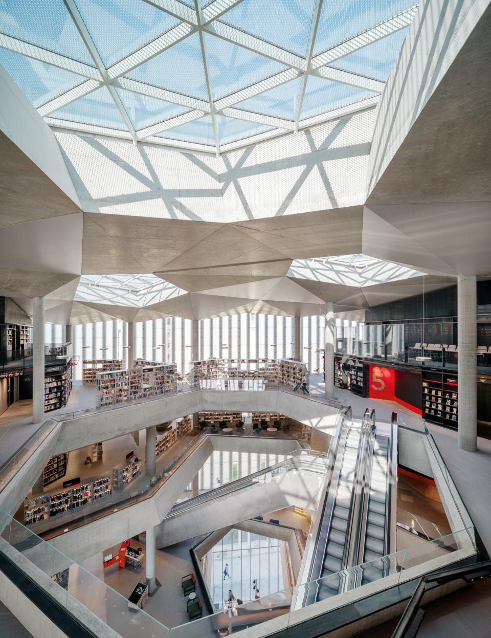 The interiors are light-filled due to the abundant windows, open spaces throughout, and a central skylight.