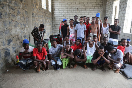 Somali refugees who survived an attack on a boat off Yemen's coast in the Red Sea pose for a group photo as they wait at a detention center in the Houthi-held port of Hodeidah, Yemen, March 22, 2017. Picture taken March 22. REUTERS/Abduljabbar Zeyad