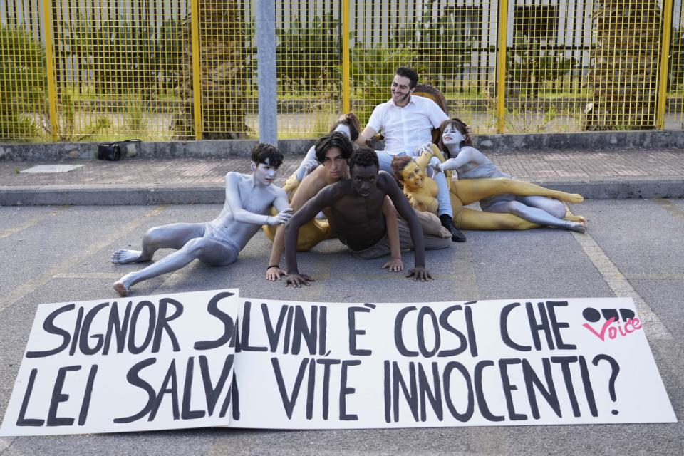 Demonstrators show a placard reading "Mr. Salvini is this how you save innocent lives?" as they stage a protest outside Palermo's court where the trial of Former minister of interior Matteo Salvini has started in Palermo, Saturday, Oct. 23, 2021. Salvini is accused of kidnapping more than one hundred migrants and keeping them for weeks on board of the small Open Arms rescue boat in front of the coasts of Lampedusa, after refusing to let it dock in an Italian port, in 2019. (AP Photo/Gregorio Borgia)