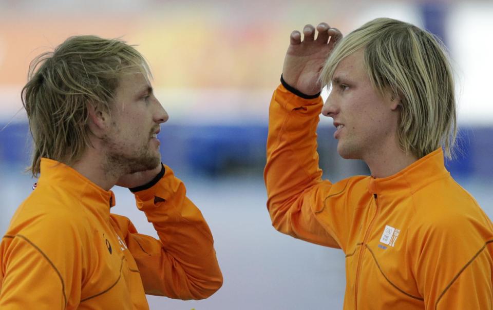 Twin brothers from the Netherlands, gold medallist Michel Mulder, left, and bronze medallist Ronald speak after the men's 500-meter speedskating race at the Adler Arena Skating Center at the 2014 Winter Olympics, Monday, Feb. 10, 2014, in Sochi, Russia. (AP Photo/Matt Dunham)