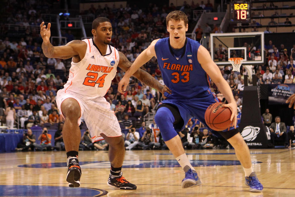 PHOENIX, AZ - MARCH 24: Erik Murphy #33 of the Florida Gators drives on Chane Behanan #24 of the Louisville Cardinals in the first half during the 2012 NCAA Men's Basketball West Regional Final at US Airways Center on March 24, 2012 in Phoenix, Arizona. (Photo by Christian Petersen/Getty Images)