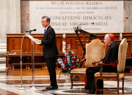 South Korean President Moon Jae-in speaks next to Italian cardinal Pietro Parolin at the end of a special mass for peace in the Korean peninsula in Saint Peter's Basilica at the Vatican, October 17, 2018. REUTERS/Max Rossi