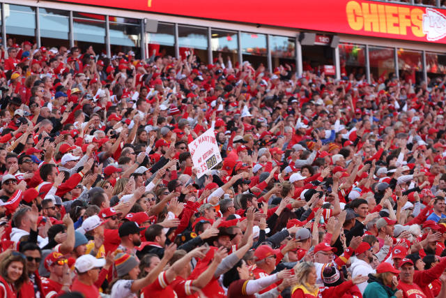 Chiefs fans wearing Native American headgear, doing Tomahawk Chop