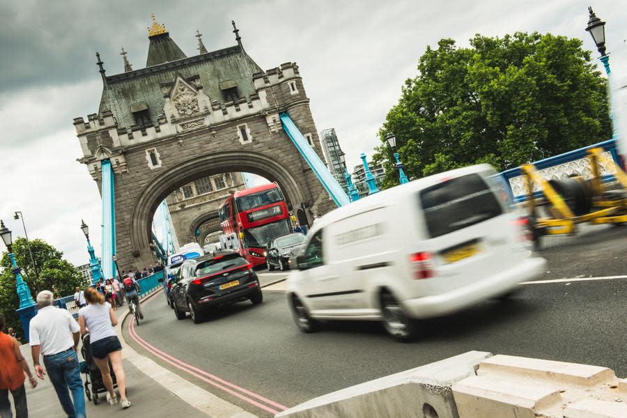 Cars and vans going over a bridge