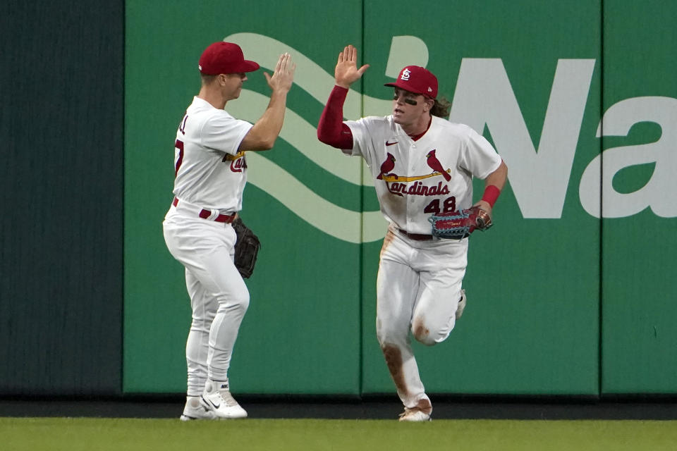 St. Louis Cardinals' Harrison Bader (48) is congratulated by teammate Tyler O'Neill after making a leaping catch at the wall on a fly ball by Arizona Diamondbacks' Pavin Smith to end the top of the third inning of a baseball game Thursday, April 28, 2022, in St. Louis. (AP Photo/Jeff Roberson)