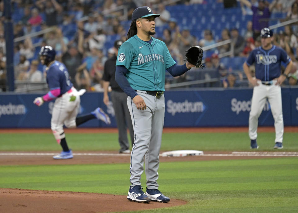 Seattle Mariners starter Luis Castillo waits for a new ball as Tampa Bay Rays' Yandy Díaz, left, runs the bases on a solo home run during the first inning of a baseball game Tuesday, June 25, 2024, in St. Petersburg, Fla. (AP Photo/Steve Nesius)