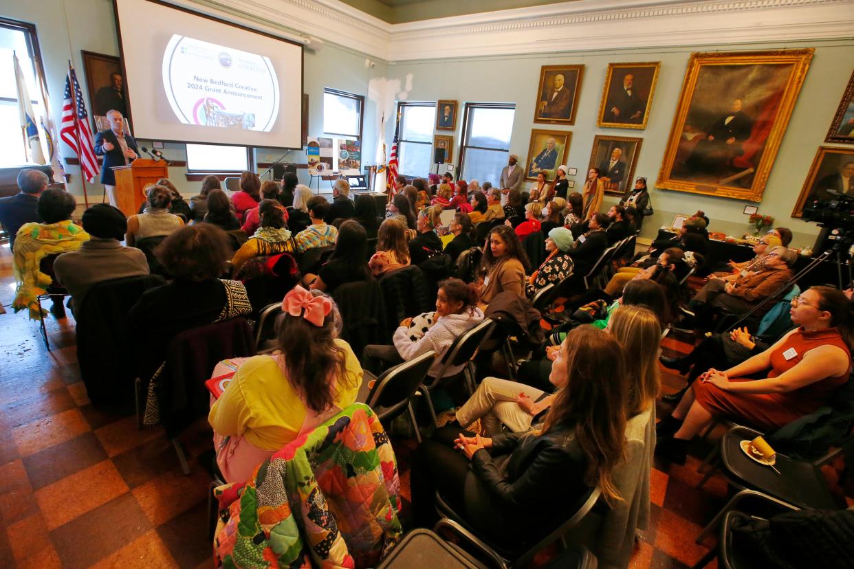 Mayor Jon Mitchell speaks during a press conference where New Bedford Creative announced the release of eighty two grant awards totaling $509,200 at a ceremony held in the New Bedford Free Public Library.