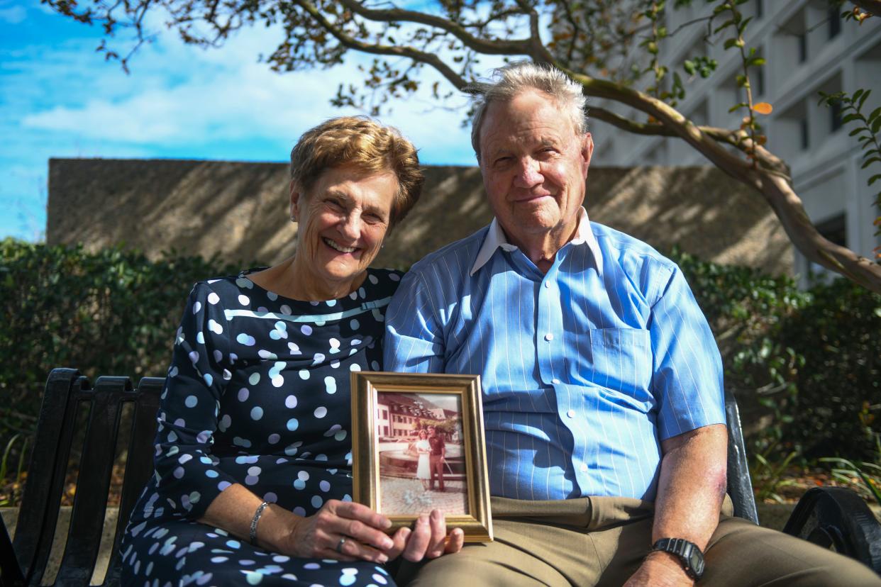 Anne and Jim Wilson hold a photo from their wedding day as they sit at Fort Eisenhower on Thursday, Nov. 9, 2023. The Wilson’s have a combined 110 years of service.