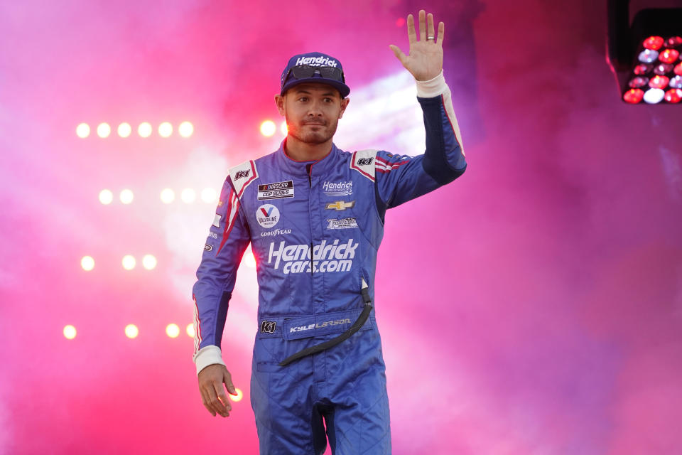 Kyle Larson (5) waves to the crowd during driver introductions prior to the start of the NASCAR Cup series auto race in Richmond, Va., Saturday, Sept. 11, 2021. (AP Photo/Steve Helber)