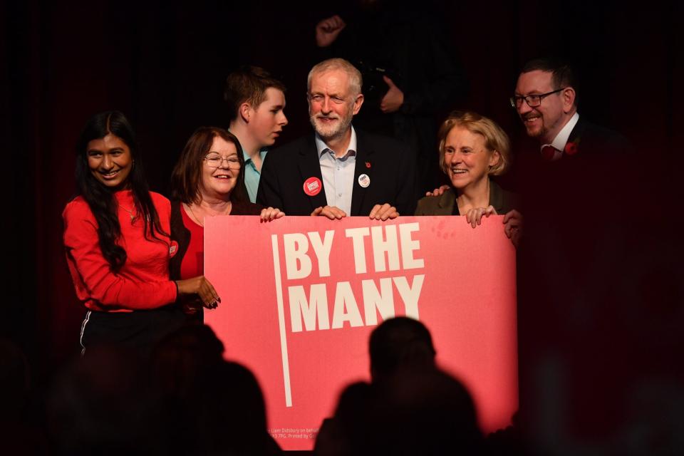 Labour leader Jeremy Corbyn with activists after he made a speech at the Library Theatre (PA)