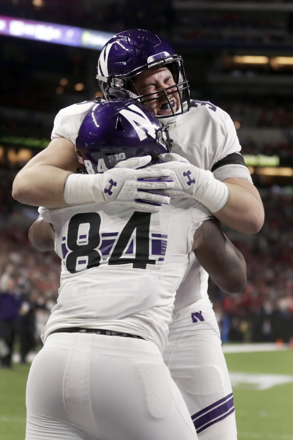 Northwestern wide receiver Cameron Green (84) celebrates a touchdown with teammate Trey Klock during the second half of the Big Ten championship NCAA college football game against Ohio State, Saturday, Dec. 1, 2018, in Indianapolis. (AP Photo/Michael Conroy)