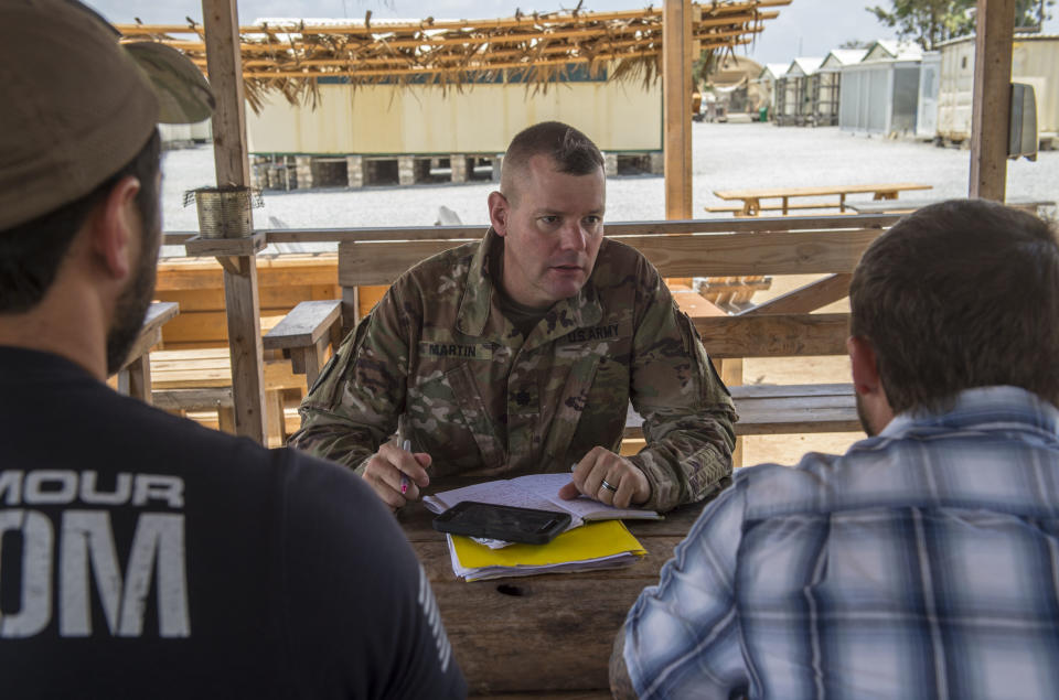 In this photo taken Feb. 24, 2018 and released by the U.S. Air Force, U.S. Army Lt. Col. Todd Martin, safety officer assigned to the Combined Joint Task Force - Horn of Africa (CJTF-HOA) Safety directorate, speaks with CJTF-HOA personnel assigned to Camp Simba, Manda Bay, Kenya, about safety concerns during a battlefield circulation site visit at Camp Simba in Manda Bay, Kenya. The al-Shabab extremist group said Sunday, Jan. 5, 2020 that it has attacked the Camp Simba military base used by U.S. and Kenyan troops in coastal Kenya, while Kenya's military says the attempted pre-dawn breach was repulsed and at least four attackers were killed. (Staff Sgt. Timothy Moore/U.S. Air Force via AP)