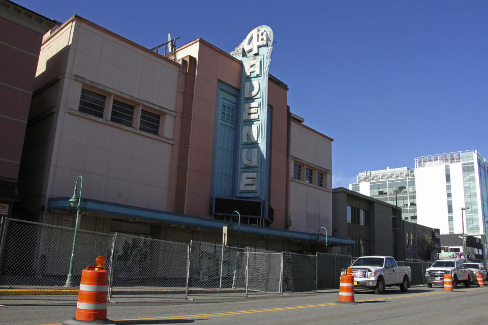 ** HOLD FOR STORY ** Fencing surrounds the 4th Avenue Theatre in Anchorage, Alaska, on Wednesday, Aug. 3, 2022. Demolition will begin in August 2022 on the once-opulent downtown Anchorage movie theater designed by the architect of Hollywood's famed Pantages Theatre. The 4th Avenue Theatre with nearly 1,000 seats opened in 1947, and it withstood the second most powerful earthquake ever recorded. (AP Photo/Mark Thiessen)