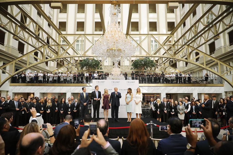 Republican presidential nominee Donald Trump and his family, from left, son Donald Trump Jr, son Eric Trump, wife Melania Trump and daughters Tiffany Trump and Ivanka Trump prepare to cut the ribbon at the new Trump International Hotel Oct. 26, 2016 in Washington, DC. The hotel, built inside the historic Old Post Office, has 263 luxury rooms, including the 6,300-square-foot 'Trump Townhouse' at $100,000 a night, with a five-night minimum. The Trump Organization was granted a 60-year lease to the historic building by the federal government before the billionaire New York real estate mogul announced his intent to run for president. 