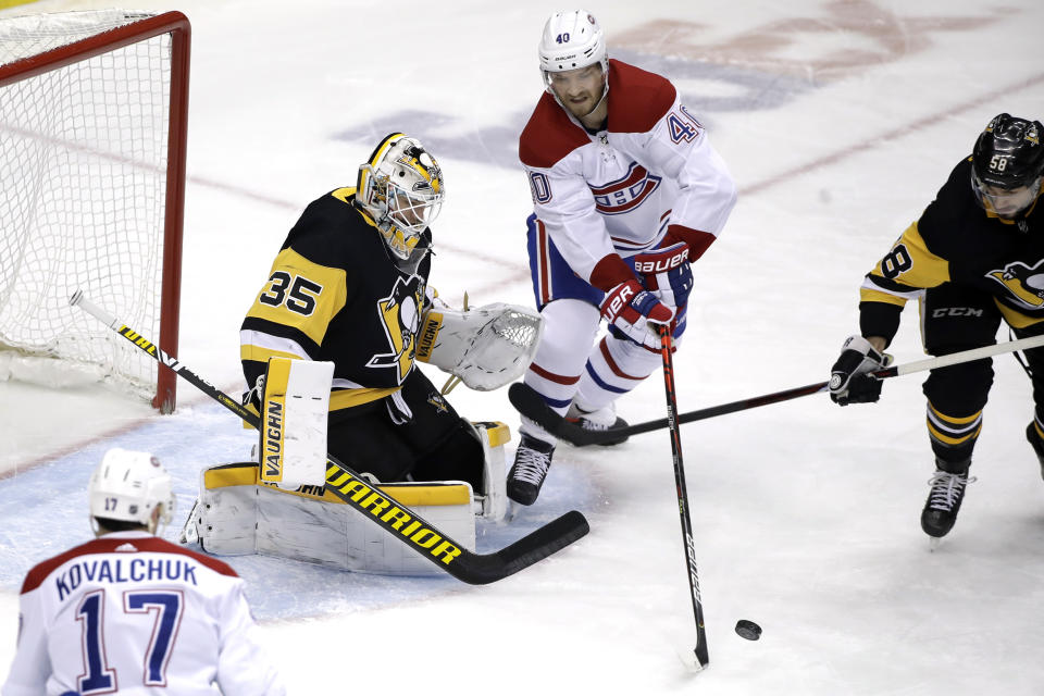 Montreal Canadiens' Joel Armia (40) can't get a shot off in front of Pittsburgh Penguins goaltender Tristan Jarry (35) with Kris Letang (58) defending during the first period of an NHL hockey game in Pittsburgh, Friday, Feb. 14, 2020. (AP Photo/Gene J. Puskar)