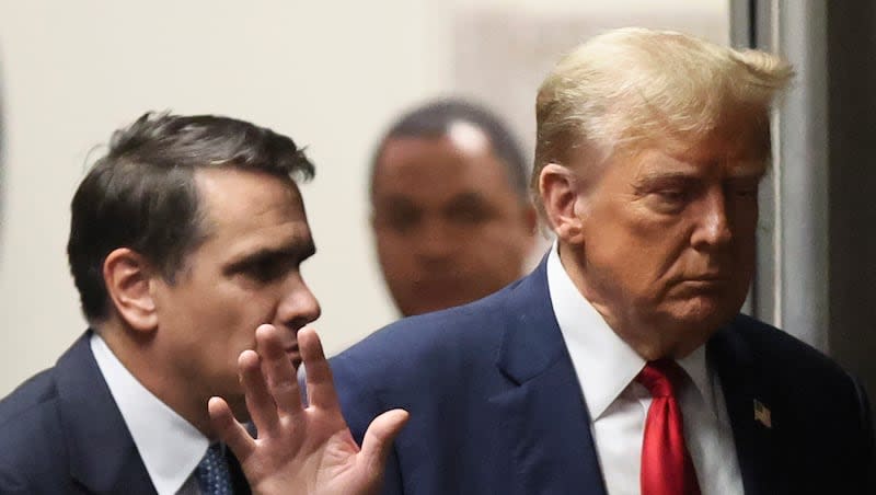 Republican presidential candidate and former President Donald Trump walks with his attorney, Todd Blanche, in Manhattan criminal court in New York, Tuesday, April 23, 2024.