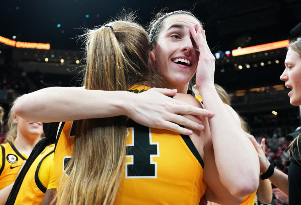 Mar 6, 2022; Indianapolis, IN, USA;  Iowa Hawkeyes guard Caitlin Clark (22) celebrates with Iowa Hawkeyes forward AJ Ediger (34) after defeating Indiana in the Big Ten conference tournament championship game at Gainbridge Fieldhouse. Mandatory Credit: Robert Goddin-USA TODAY Sports