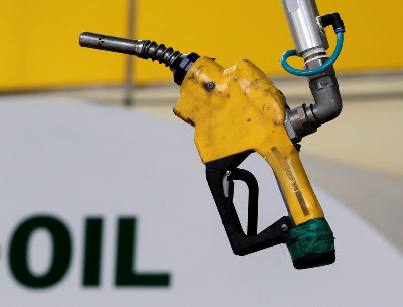 FILE PHOTO: A gas pump is seen hanging from the ceiling at a petrol station in Seoul