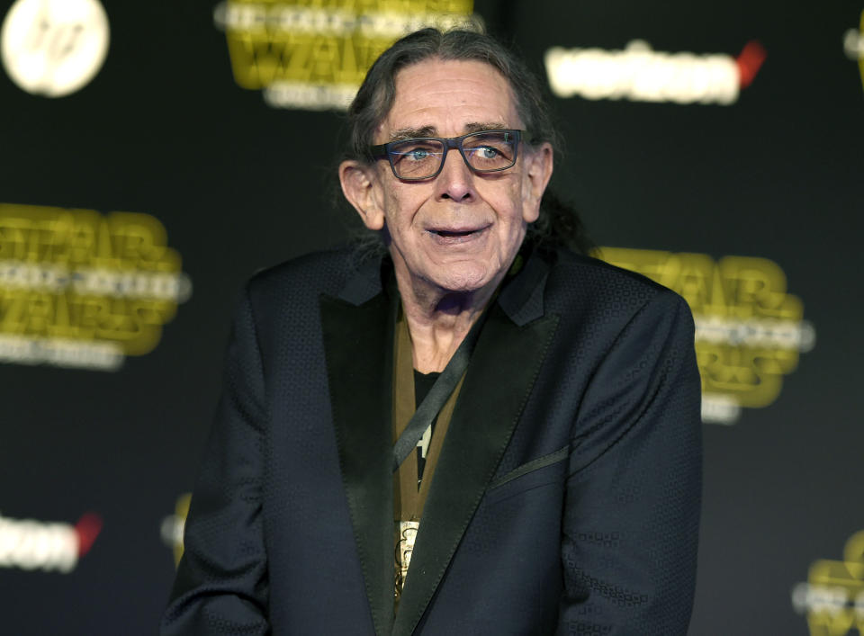 RETRANSMISSION TO CORRECT DAY AND DATE OF DEATH - FILE - In this Dec. 14, 2015, file photo, Peter Mayhew arrives at the world premiere of "Star Wars: The Force Awakens" in Los Angeles. Mayhew, who played the rugged, beloved and furry Wookiee Chewbacca in the “Star Wars” films, has died. Mayhew died at his home in north Texas on Tuesday, April 30, 2019 according to a family statement. He was 74. No cause was given. (Photo by Jordan Strauss/Invision/AP, File)