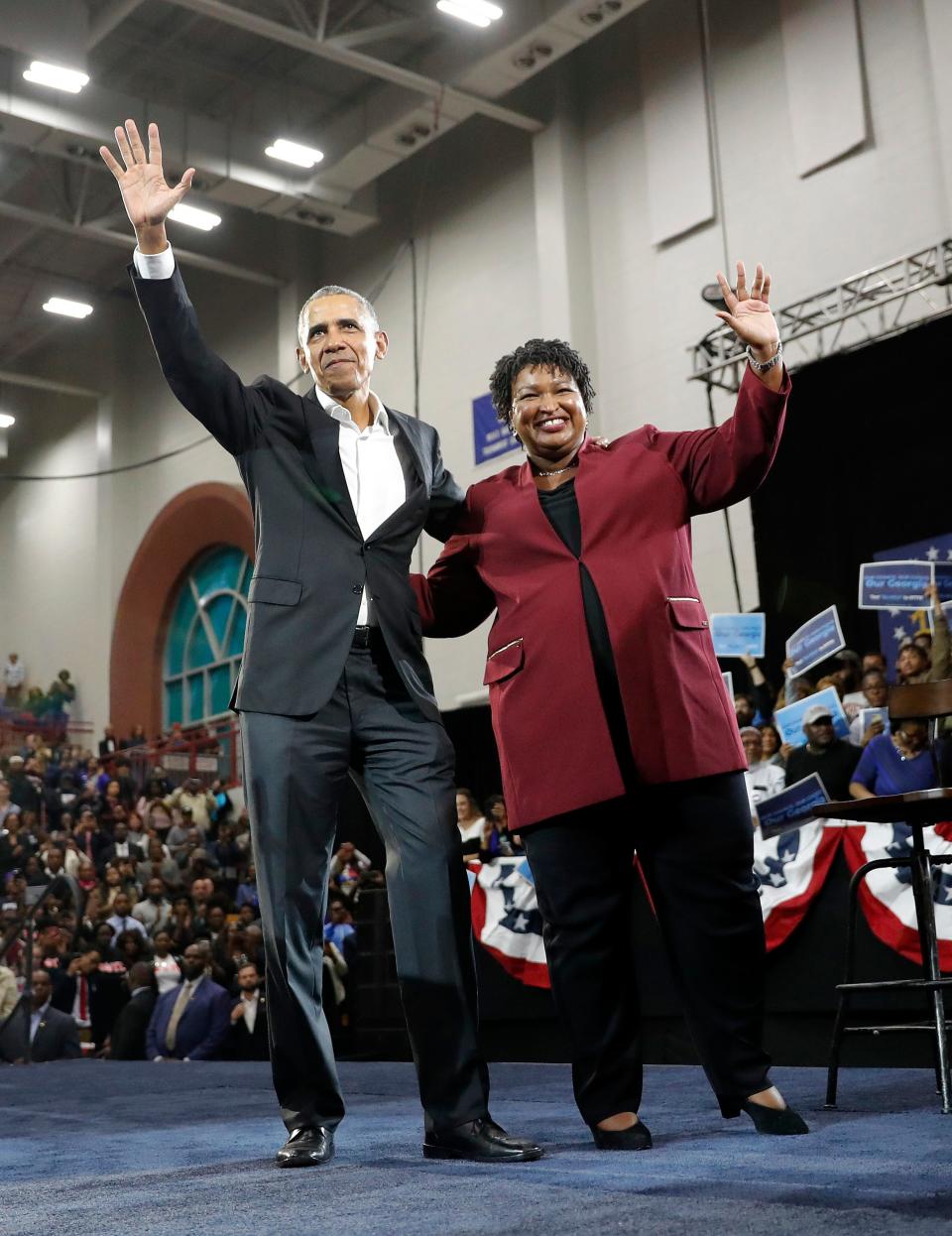 Former President Barack Obama and Democratic candidate for Georgia Governor Stacey Abrams wave to the crowd during a campaign rally at Morehouse College on Nov. 2, 2018, in Atlanta.
