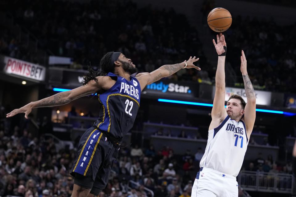 Dallas Mavericks guard Luka Doncic (77) shoots over Indiana Pacers forward Isaiah Jackson (22) during the first half of an NBA basketball game in Indianapolis, Monday, March 27, 2023. (AP Photo/Michael Conroy)