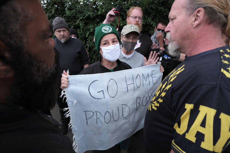 Anti-fascist counter-protesters confront Proud Boys as they rally on the outskirts of town on Sunday, Aug. 22, 2021, in Portland, Ore. (AP Photo/Alex Milan Tracy)