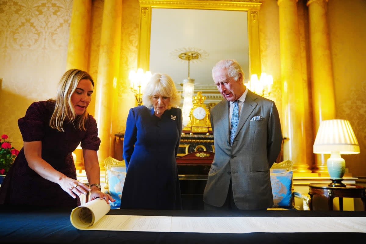 King Charles III and Queen Camilla are presented with the Coronation Roll, an official record of their Coronation (Victoria Jones/PA Wire)