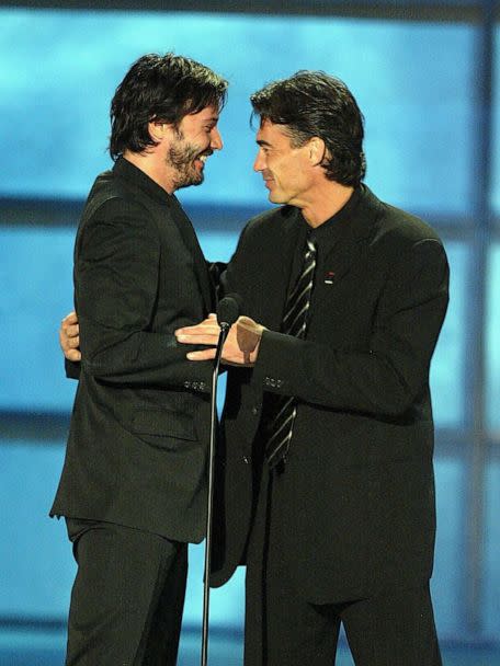 PHOTO: Keanu Reeves accepts the honorary award for 'Action Movie Star' from stunt double Chad Stahelski at the 4th Annual Taurus World Stunt Awards at Paramount Pictures May 16, 2004 in Los Angeles. (Kevin Winter/Getty Images)