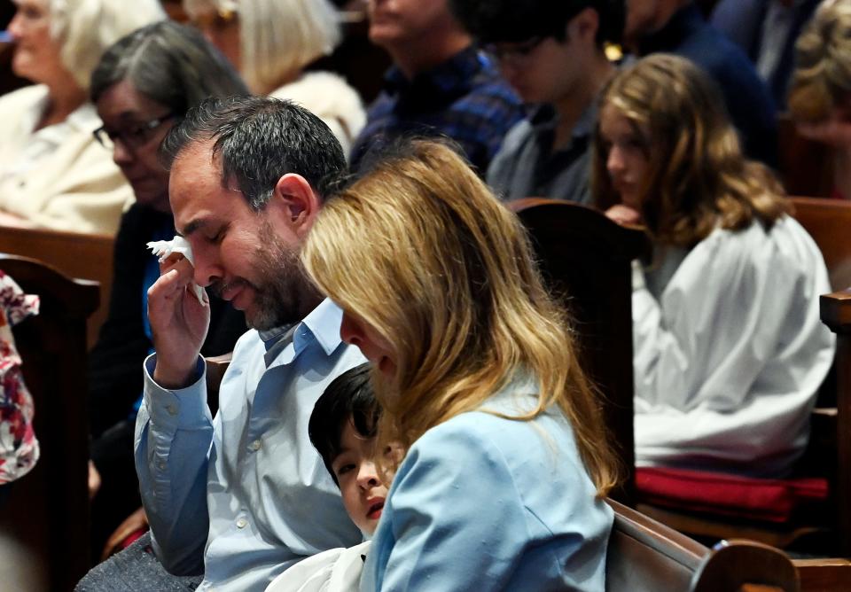 A congregation member cries as the names of the victims of the mass shooting at Covenant School were read during a Palm Sunday service at Belmont United Methodist Church Sunday, April 2, 2023, in Nashville, Tenn.   