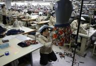 North Korean employees work in a factory of a South Korean company at the Joint Industrial Park in Kaesong industrial zone, a few miles inside North Korea from the heavily fortified border December 19, 2013. Kaesong, with investors from South Korea, was a rare source of hard currency for North Korea. It was established even though North Korea is technically still at war with South Korea, one of the world's richest countries, since the 1950-53 Korean War ended not in a treaty but a truce. Since it opened in 2004, the Kaesong complex has generated about $90 million annually in wages paid directly to the North's state agency that manages the zone. REUTERS/Kim Hong-Ji (NORTH KOREA - Tags: POLITICS BUSINESS EMPLOYMENT)