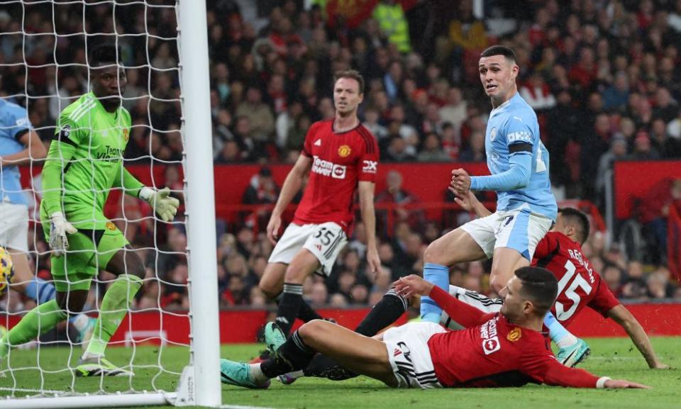 Phil Foden scores Manchester City’s third goal in their 3-0 win against Manchester United at Old Trafford.