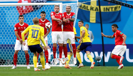 Soccer Football - World Cup - Round of 16 - Sweden vs Switzerland - Saint Petersburg Stadium, Saint Petersburg, Russia - July 3, 2018 Switzerland's Granit Xhaka, Blerim Dzemaili, Josip Drmic and Valon Behrami in the defensive wall as Sweden's Emil Forsberg shoots at goal from a free kick REUTERS/Damir Sagolj