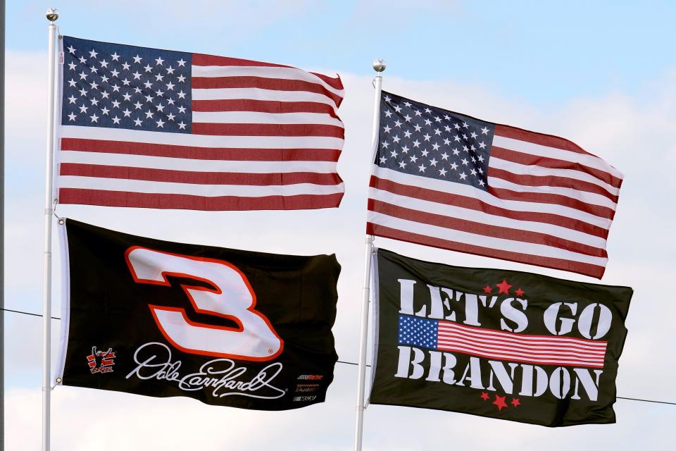 A "Let's Go Brandon" flag flies with others on Feb. 18, 2022, at Daytona International Speedway in Daytona Beach, Fla.