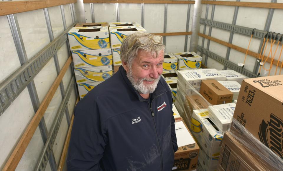 In this 2019 photo, Don Cox, president of the Massachusetts Military Support Foundation, stands next to a load of food picked up in Boston to be delivered at Joint Base Cape Cod.