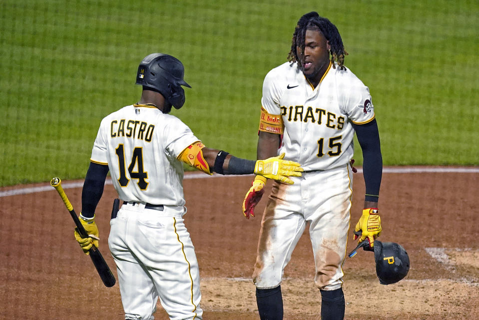 Pittsburgh Pirates' Oneil Cruz (15) is greeted by Rodolfo Castro after scoring on a single by Bryan Reynolds off New York Mets starting pitcher Taijuan Walker during the fifth inning of a baseball game in Pittsburgh, Tuesday, Sept. 6, 2022. (AP Photo/Gene J. Puskar)