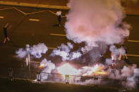 Police use flash-bang grenades to disperse protesters during a mass rally following presidential election in Minsk, Belarus, Tuesday, Aug. 11, 2020. Belarus officials say police detained over 1,000 people during the latest protests against the results of the country's presidential election. An Interior Ministry spokeswoman says rallies took place in 25 Belarusian cities on Tuesday, the third night of protests contesting the election results. (AP Photo)