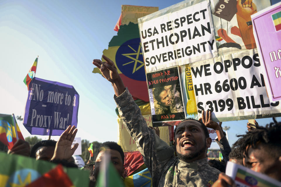 Ethiopians protest against what they say is interference by outsiders in the country's internal affairs and against the Tigray People's Liberation Front (TPLF), the party of Tigray's fugitive leaders, at a rally organized by the city administration in the capital Addis Ababa, Ethiopia Saturday, Oct. 22, 2022. The demonstrations were staged ahead of the expected start of peace talks in South Africa next week between the warring parties, with the U.S. saying Friday it supports the African Union's efforts to mediate talks to stop fighting in Tigray. Writing in Amharic on placard reads "You suffer in the hands of the enemy for me." (AP Photo)