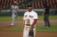 Boston Red Sox third baseman Rafael Devers walks away as Philadelphia Phillies' Bryce Harper, left, rounds the bases after his three run home run during the sixth inning of a baseball game Tuesday, Aug. 18, 2020, at Fenway Park in Boston. (AP Photo/Winslow Townson)