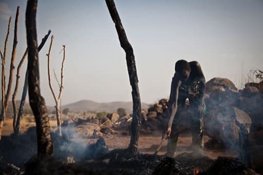 A man looks through the remains of a house destroyed by a Sudan Armed Forces airstrike, in Tabanya, in South Kordofan, a region of Sudan, on April 25. Sudan declared a state of emergency along its border with South Sudan on Sunday after month-long border clashes, as four foreigners allegedly arrested in the Heglig oil region remained in custody
