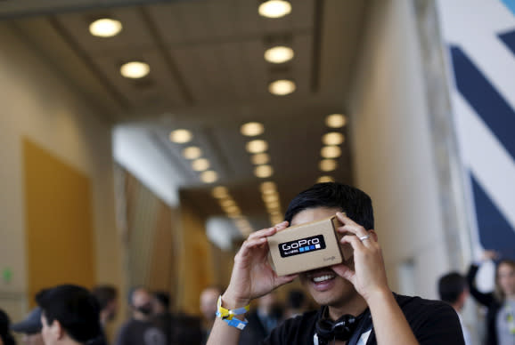 A conference attendee looks through "Cardboard," a viewer that enables the user to view content from a smart phone in 3D, during the Google I/O developers conference in San Francisco, California May 28, 2015.